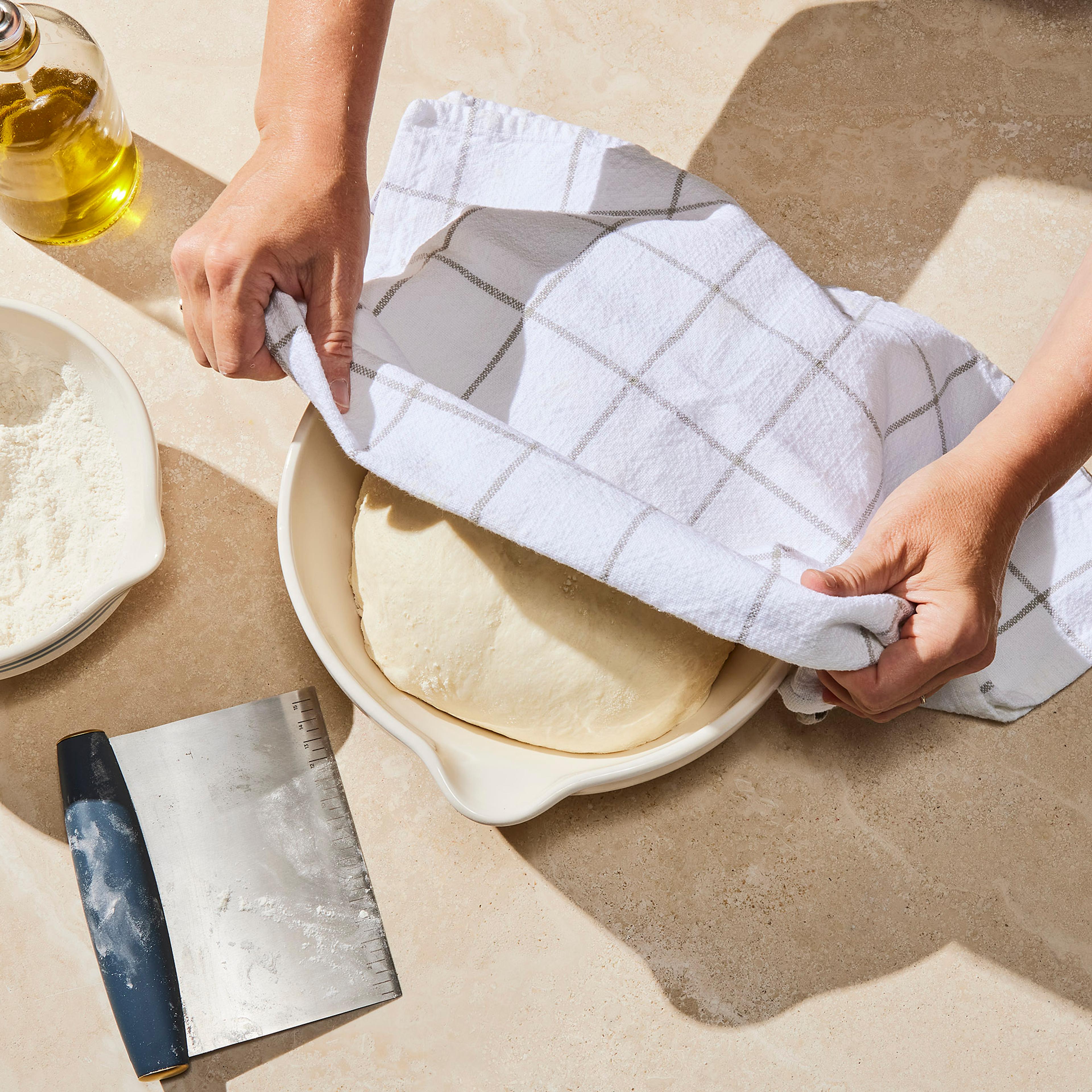 towel covering dough in a bowl