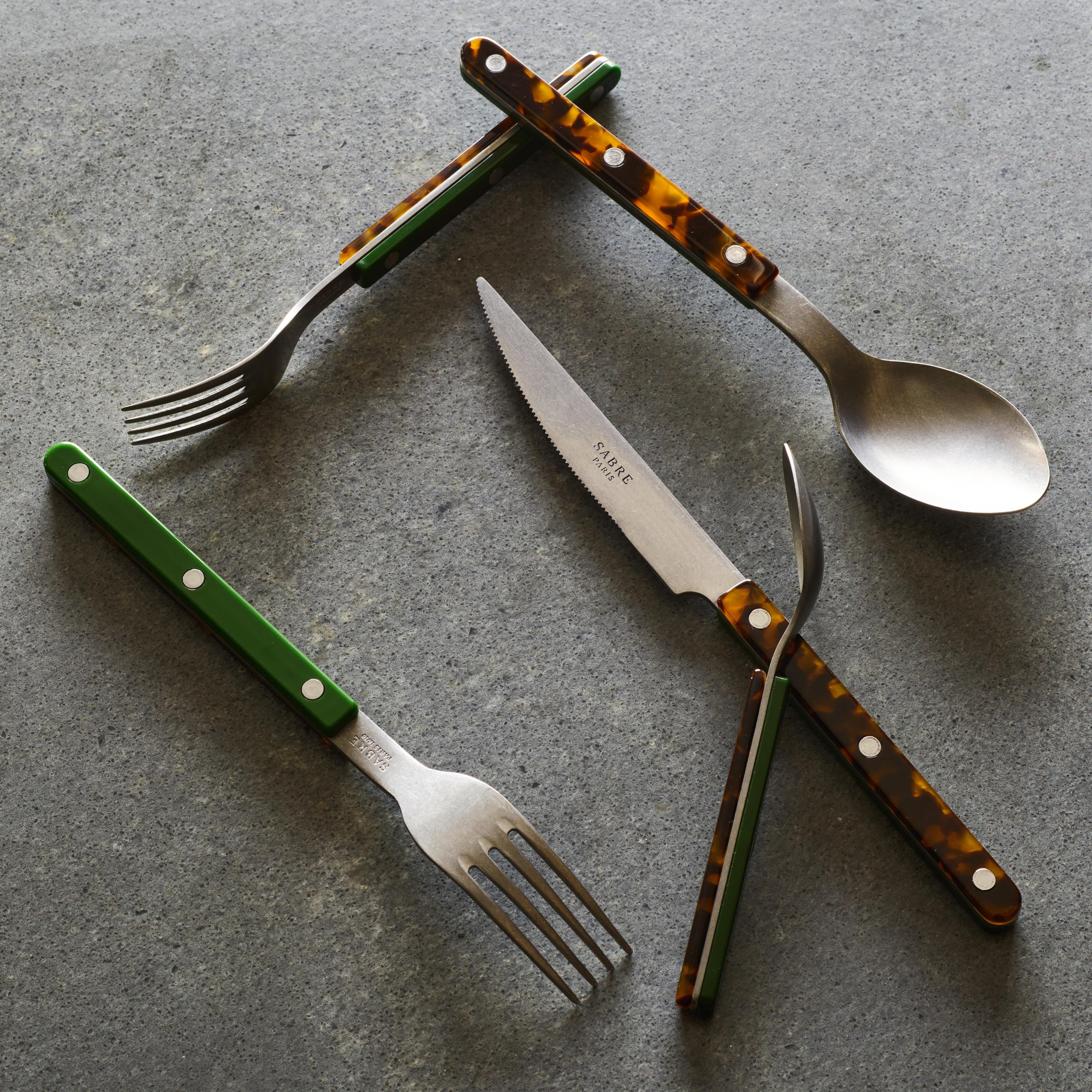 mixed color flatware on gray background