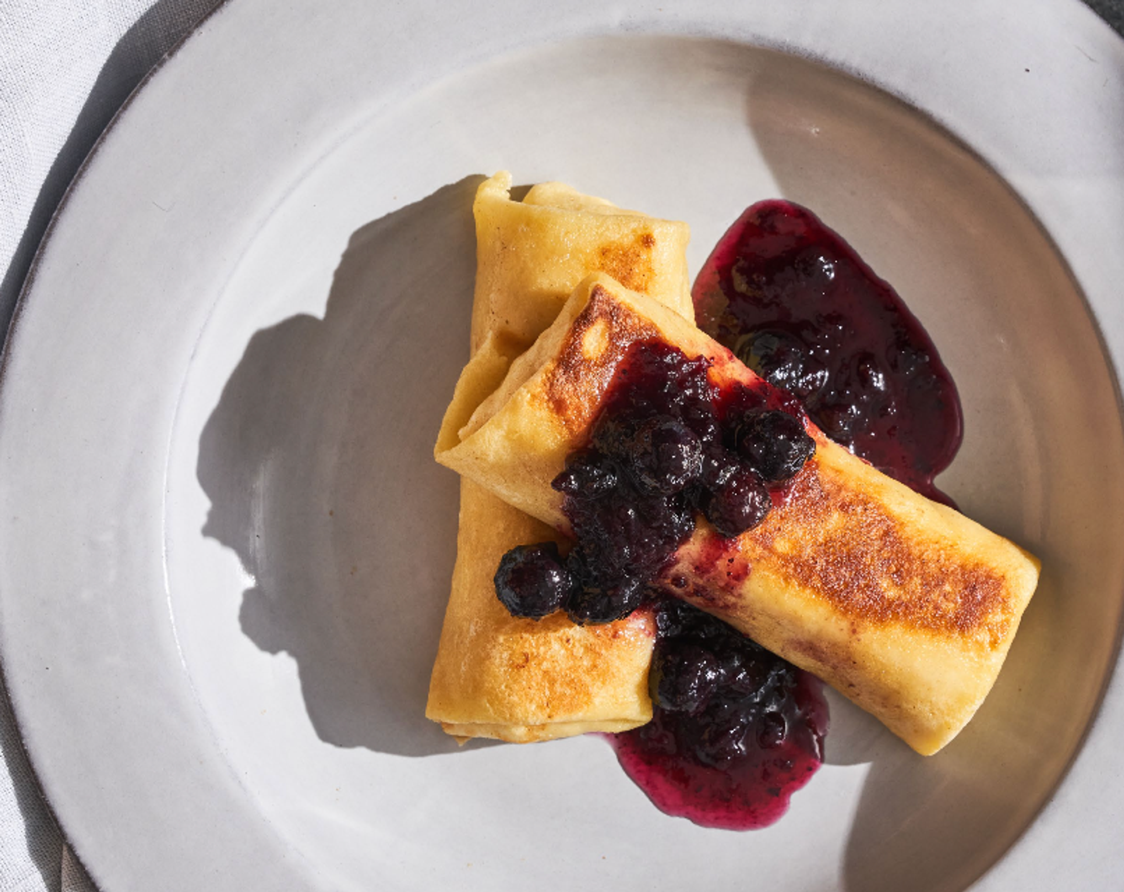 Plate of Cheese Blintzes with Blueberry Compote